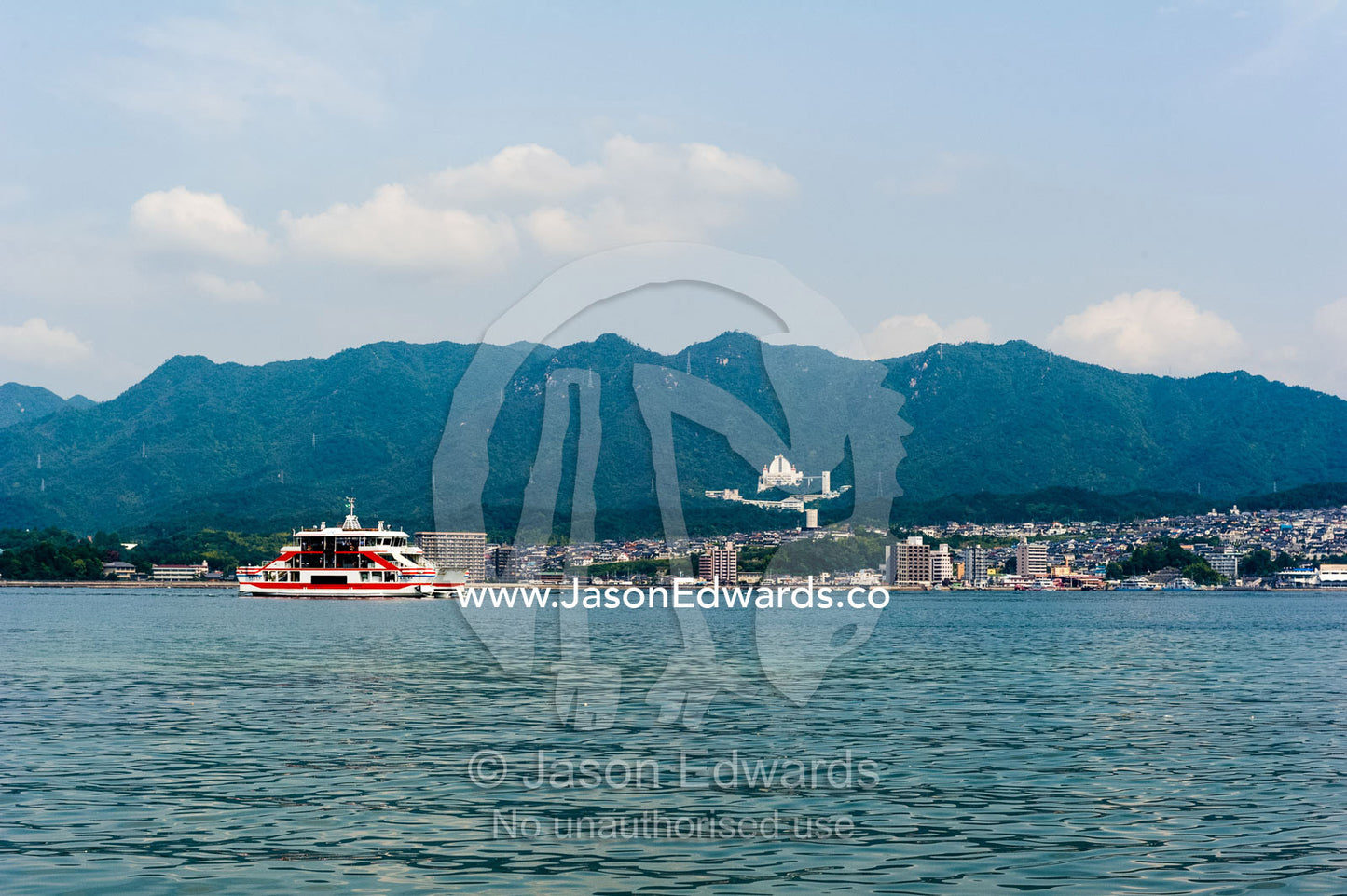A passenger ferry transporting tourists from the mainland to an island. Miyajima, Itsukushima Island, Inland Sea of Japan, Hiroshima Bay, Japan.