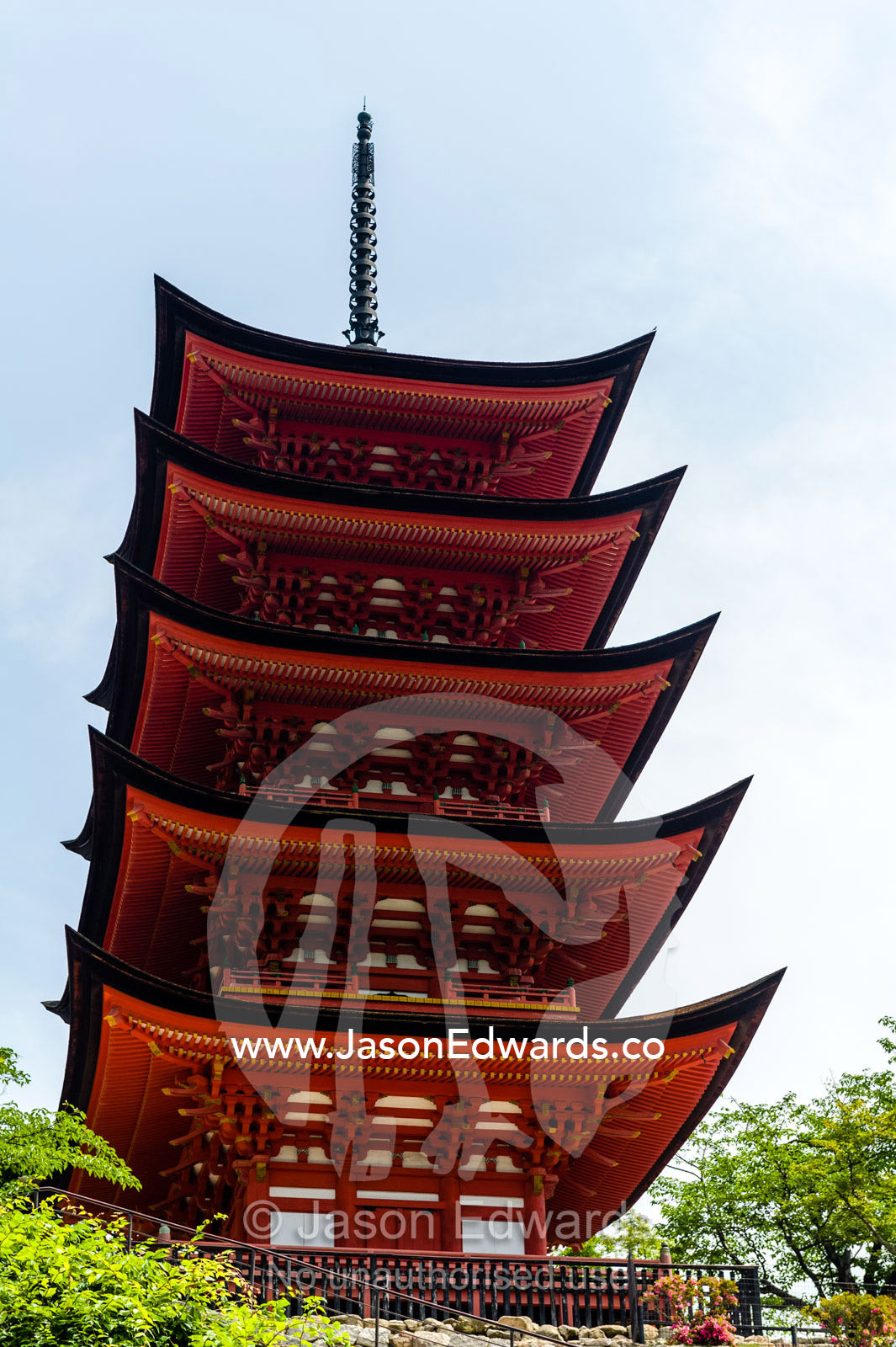 A towering red five-tiered pagoda at the Itsukushima Shrine. Toyokuni Shrine, Itsukushima Shrine, Miyajima, Itsukushima Island, Inland Sea of Japan, Hiroshima Bay, Japan.