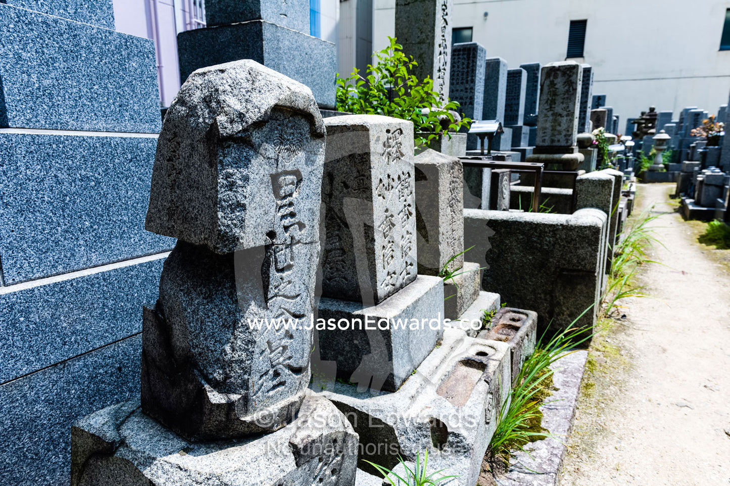 A small cemetery adjacent to the Atomic Bomb Dome where the stone on the tombstones was fused by the blast. Hiroshima Peace Memorial Park, Hiroshima, Honshu Island, Japan.