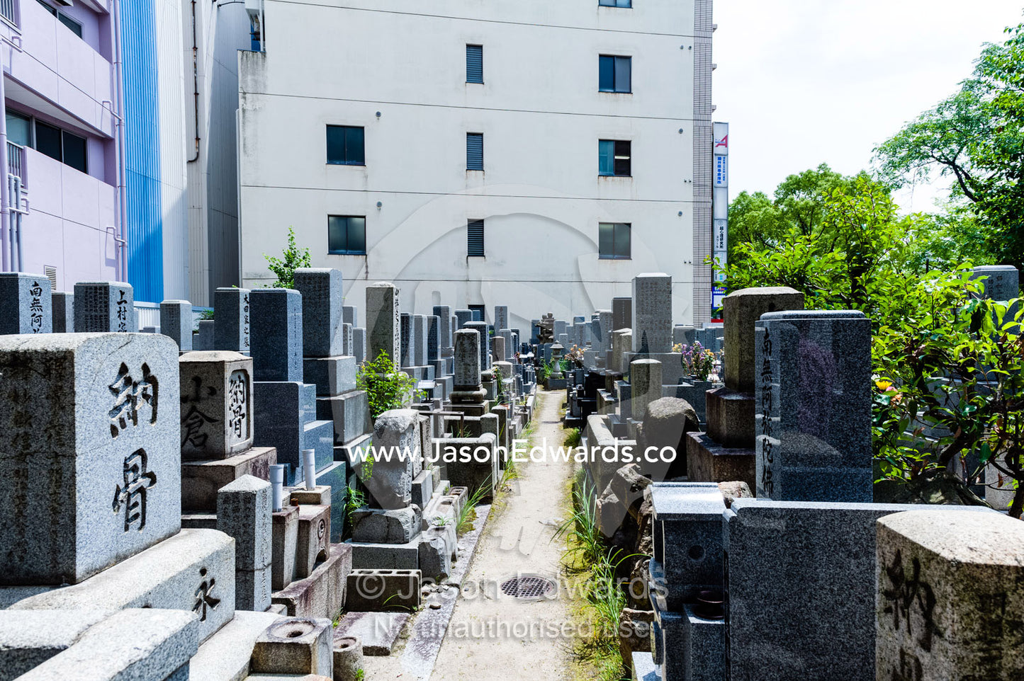 A small cemetery adjacent to the Atomic Bomb Dome where the stone on the tombstones was fused by the blast. Hiroshima Peace Memorial Park, Hiroshima, Honshu Island, Japan.
