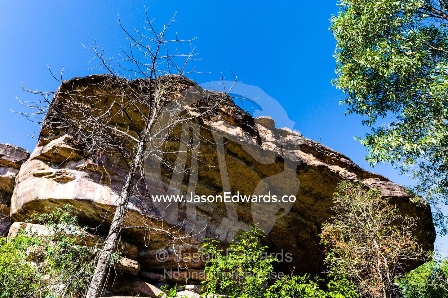 A cliff overhang on a sandstone escarpment protects an ancient Aboriginal rock painting art gallery. Ubirr, Kakadu National Park, Northern Territory, Australia.