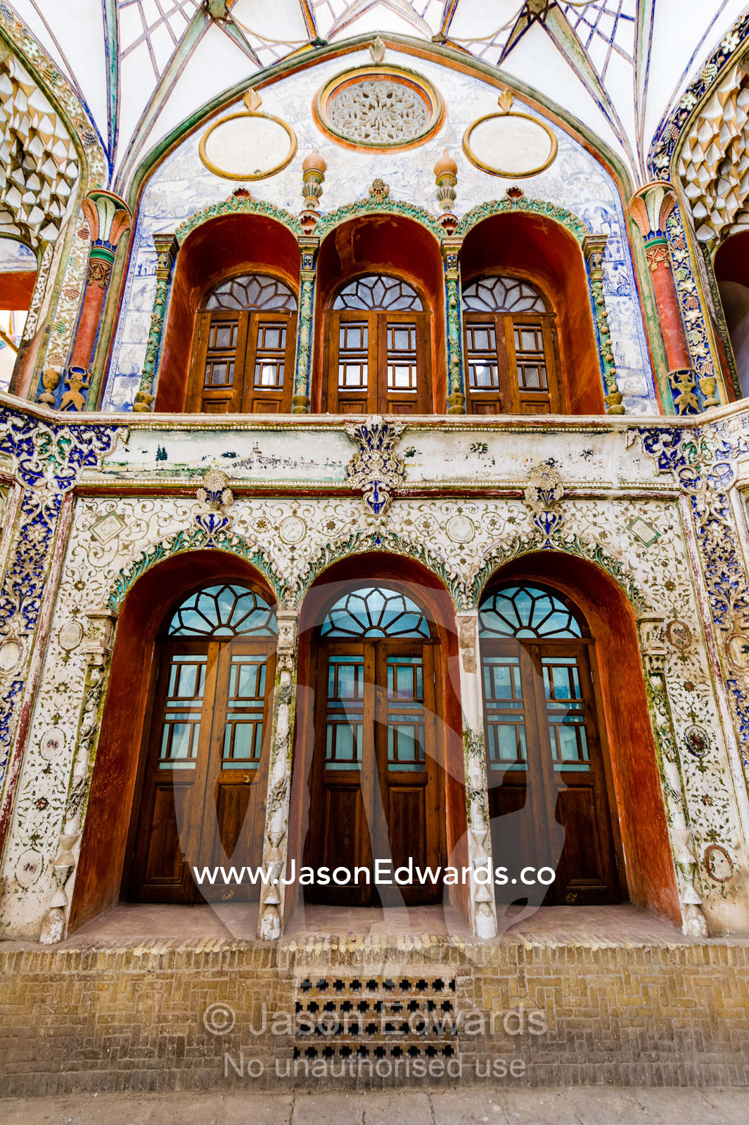 Skylights illuminate ornate timber and stained glass doors and windows in the Borujerdis House. Borujerdis House, Kashan, Isfahan Province, Islamic Republic of Iran.