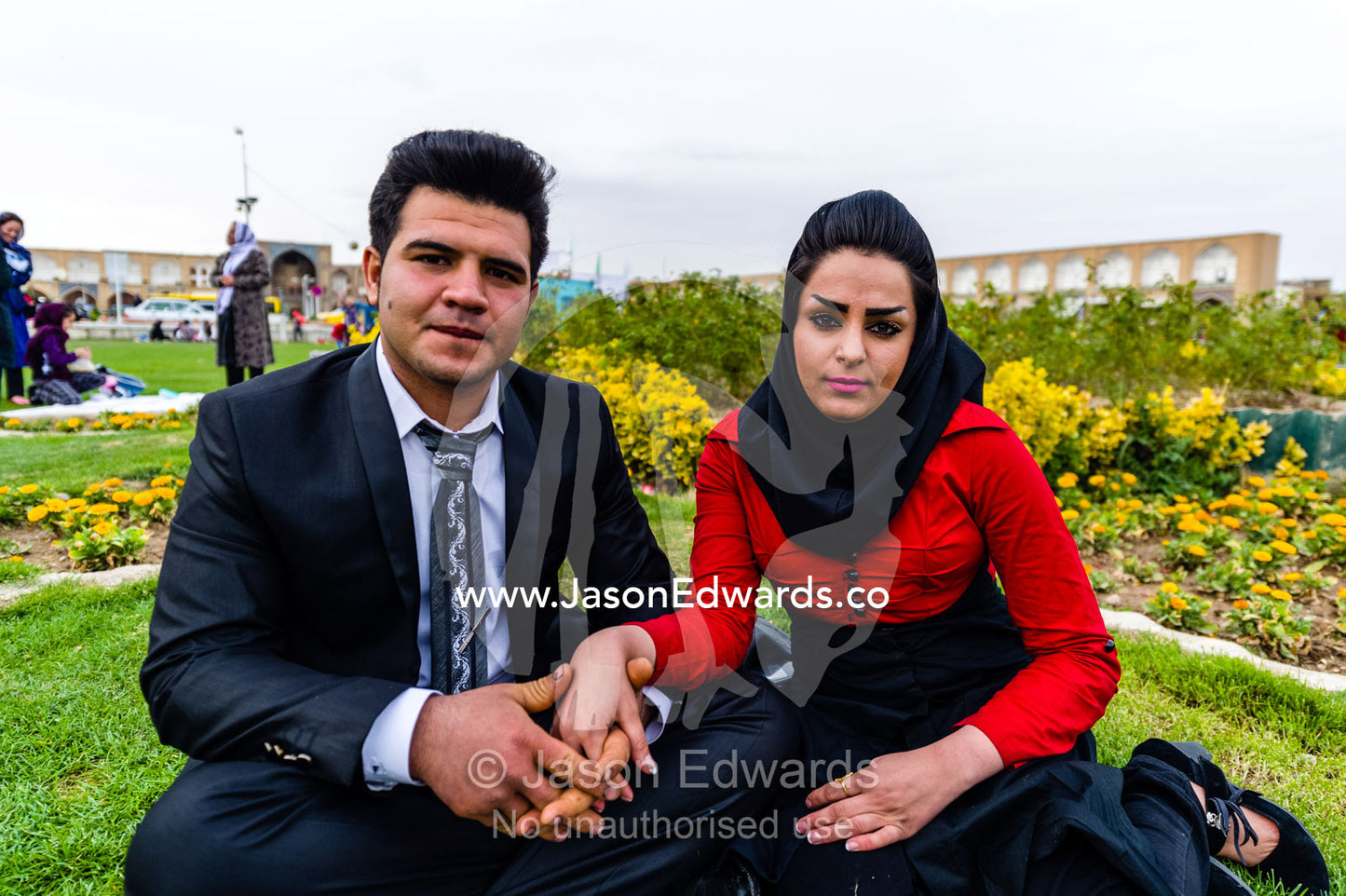 A newly married couple holding hands on the New Year holiday. Naqsh-e Jahan Square, Isfahan, Isfahan Province, Islamic Republic of Iran.