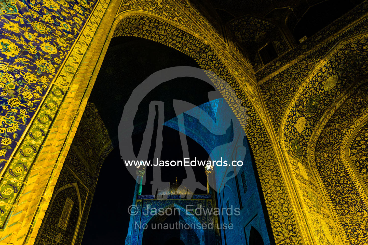 The courtyard and vaulted iwan of the Shah Mosque illuminated at night. Shah Mosque, Isfahan, Isfahan Province, Islamic Republic of Iran.
