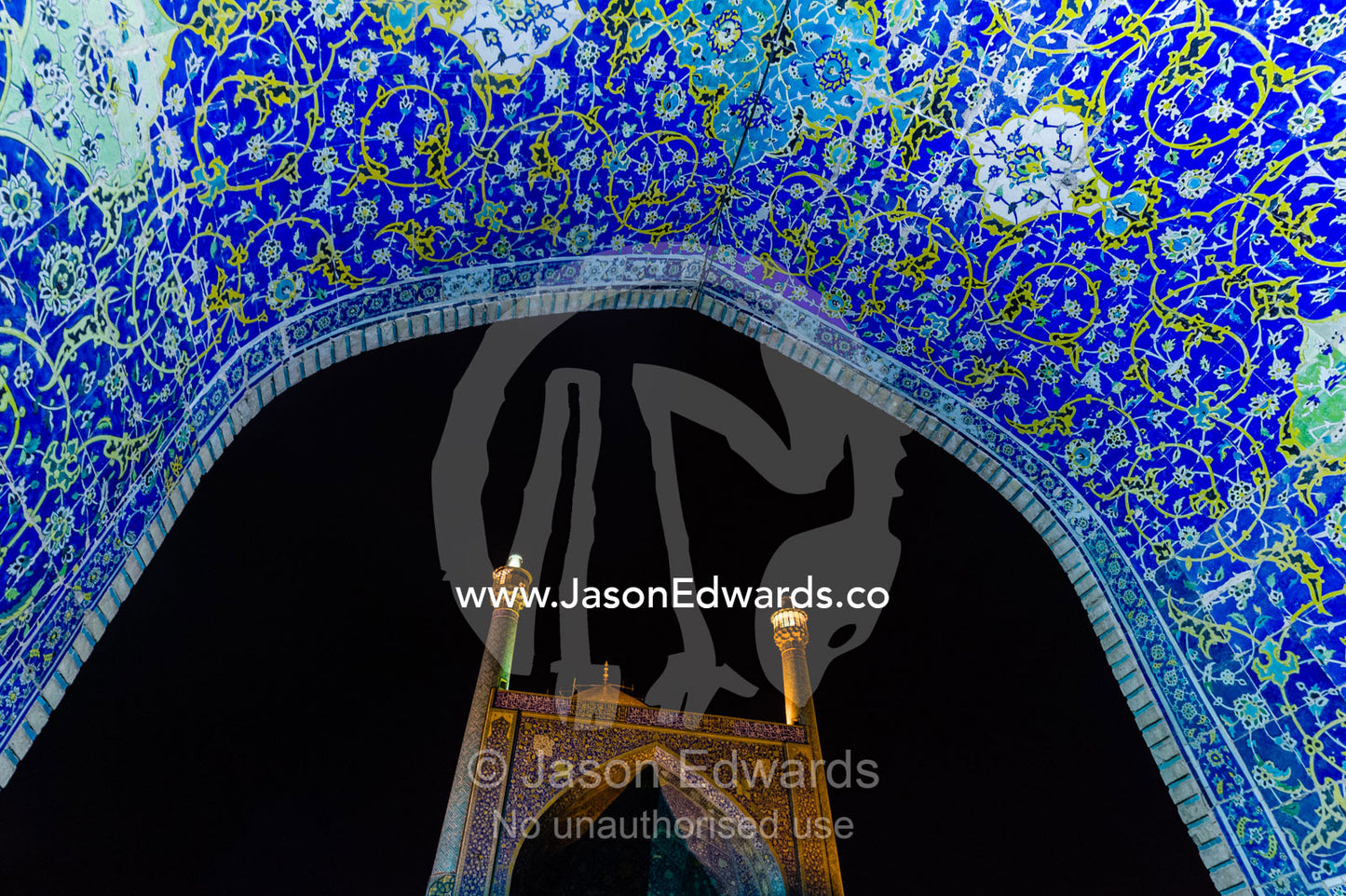 The courtyard and vaulted iwan of the Shah Mosque illuminated at night. Shah Mosque, Isfahan, Isfahan Province, Islamic Republic of Iran.