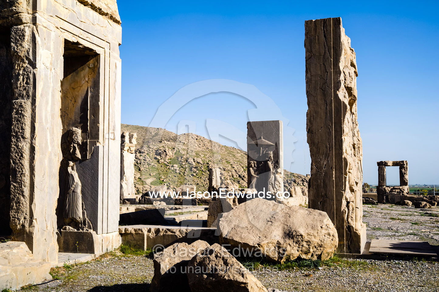 Carved stone columns and gates at the Hadish Place in Persepolis. Persepolis, Shiraz, Fars Province, Islamic Republic of Iran.