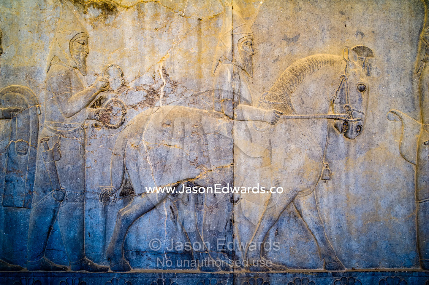 Carved bas reliefs depict envoys of the subject nations of Persia bringing gifts to the King. Persepolis, Shiraz, Fars Province, Islamic Republic of Iran.