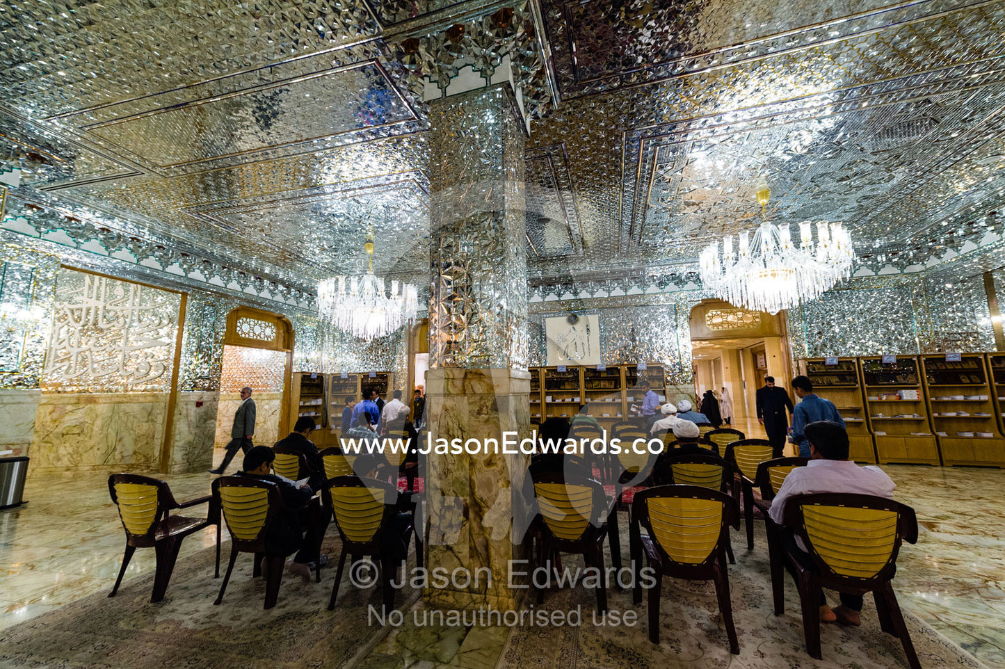 Men at prayer beneath the magnificent mirrored ceiling of the Holy shrine of Hazrat Masuma. Fatima Masumeh Shrine, Qom, Qom Province, Islamic Republic of Iran.