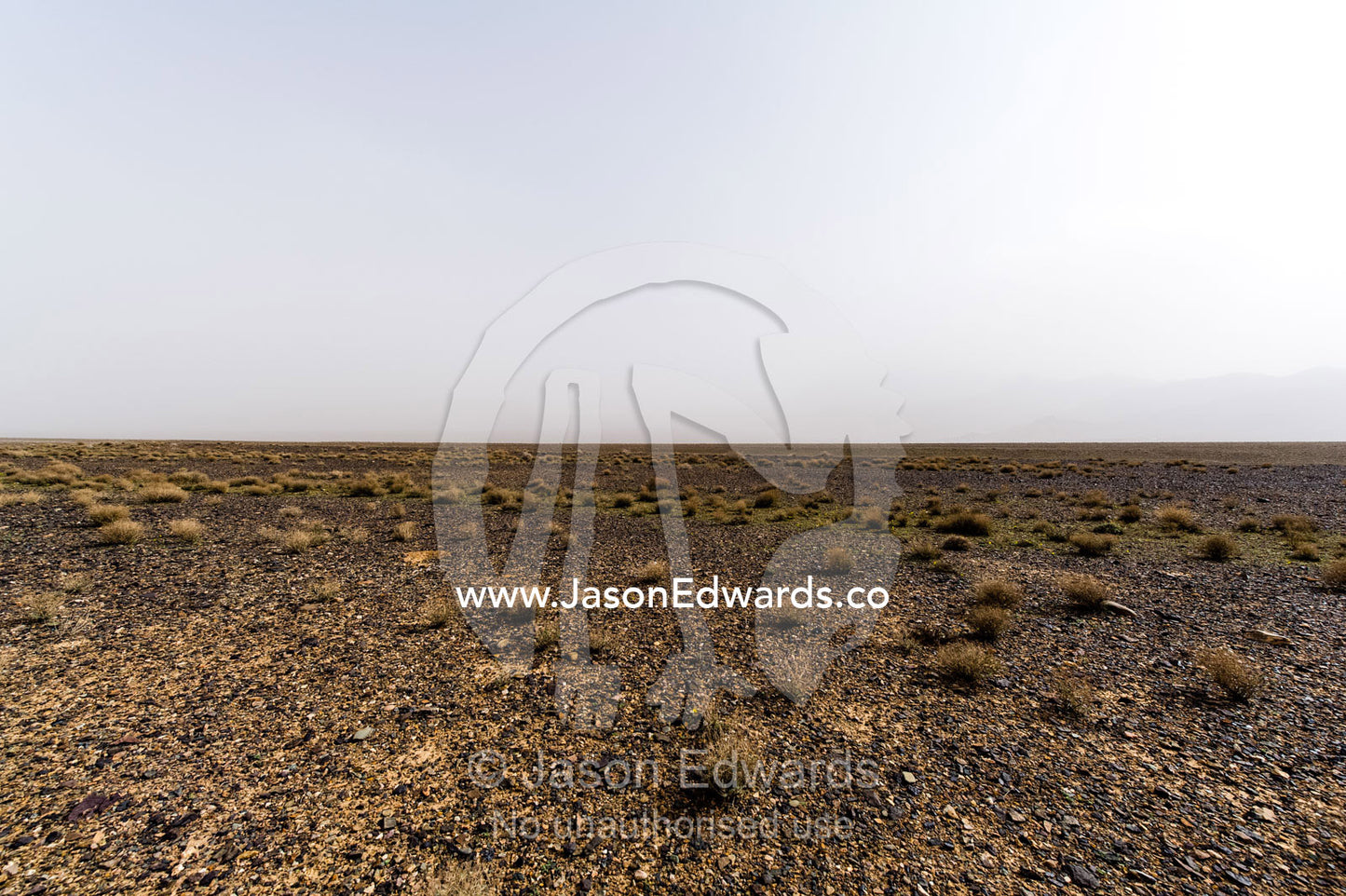 A misty morning over a barren gravel desert. Barzrud Rural District, Natanz County, Isfahan Province, Islamic Republic of Iran.