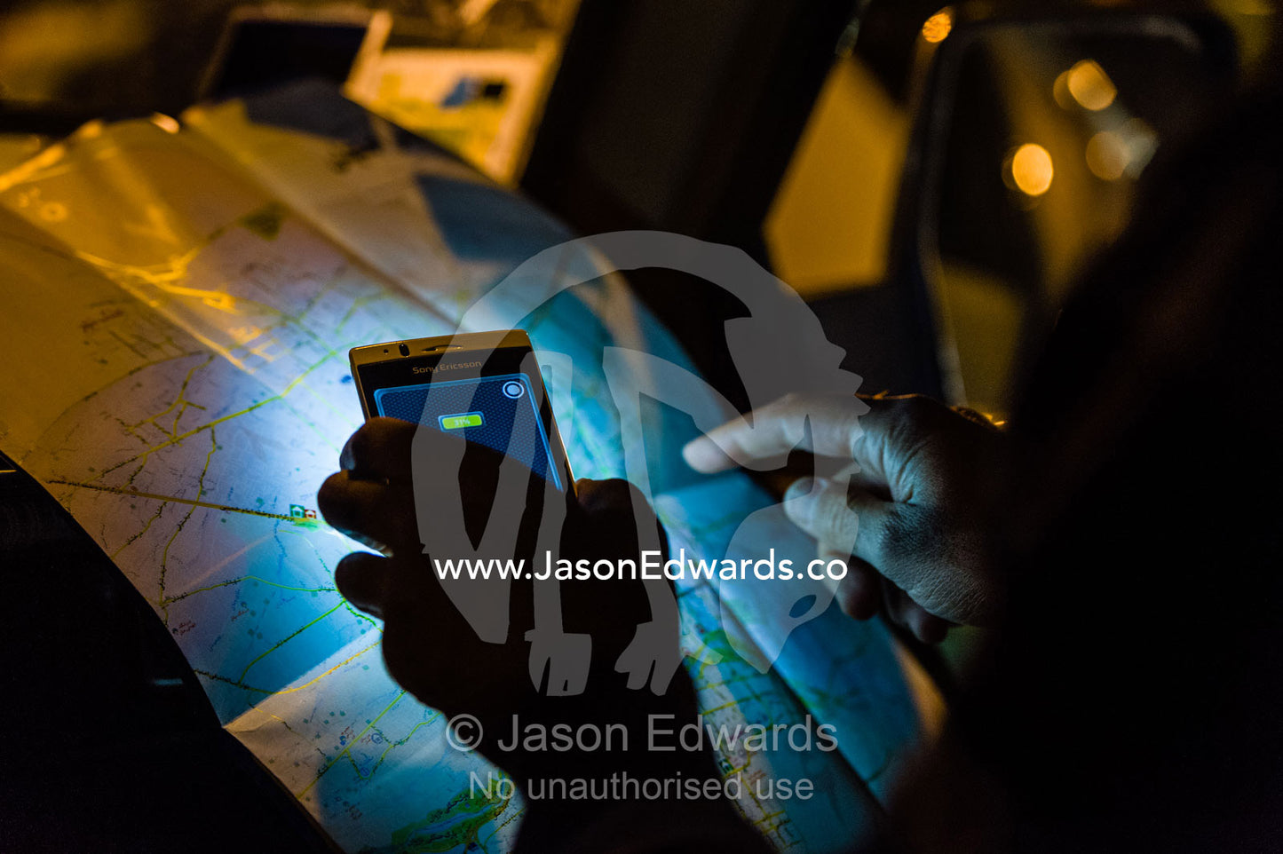 Using the torch on a cell phone to read a city map. Isfahan, Isfahan Province, Islamic Republic of Iran.