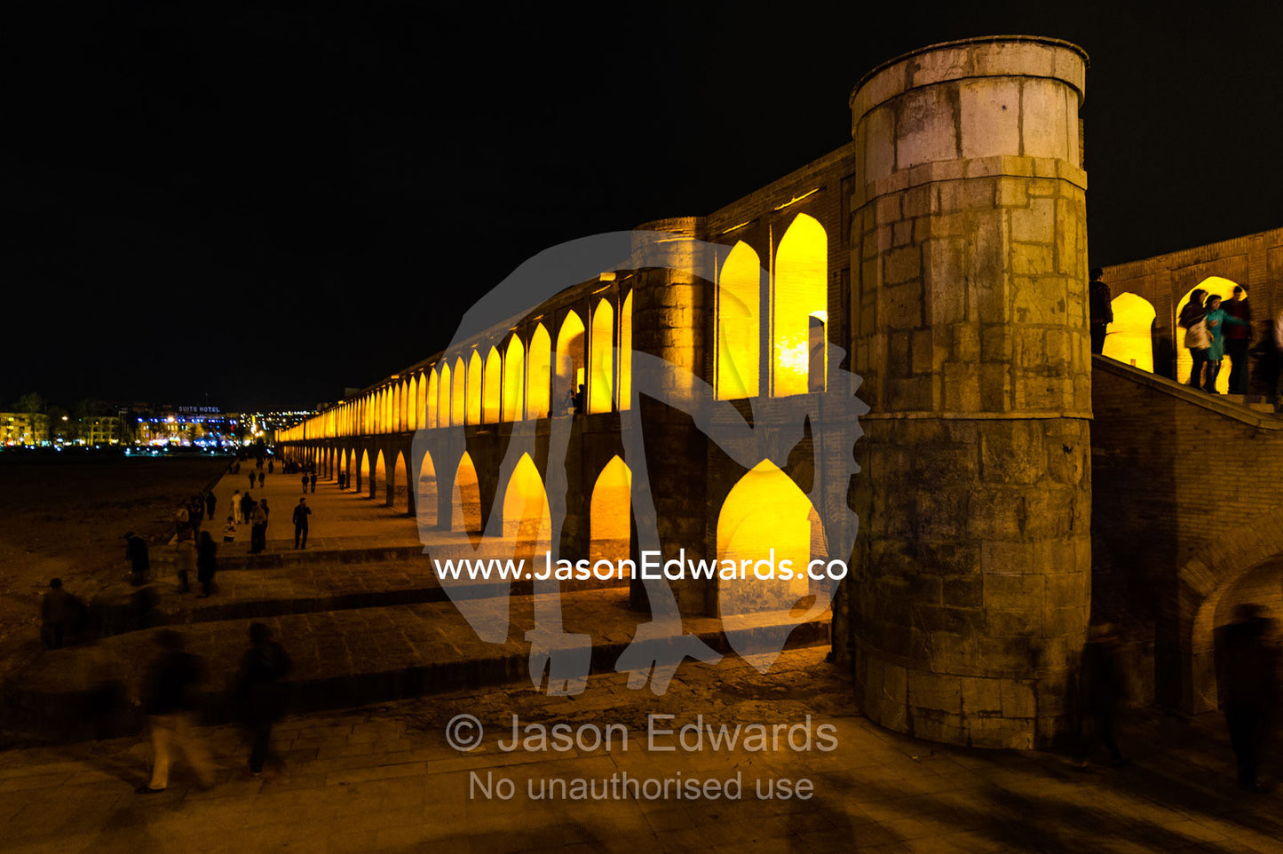 Light cascades from iwans lining the Khaju Bridge at night during Nowruz Iranian New Year. Si-o-seh pol Bridge, Zayandeh River, Isfahan, Isfahan Province, Islamic Republic of Iran.