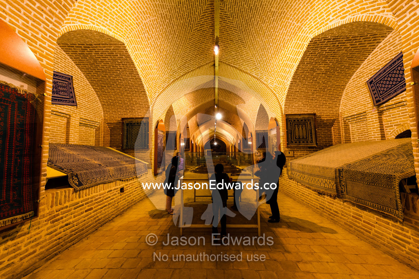 An Iranian family examines displays in a museum in an ancient caravanserai. Meybod Caravanserai and Carpet Museum, Meybod, Meybod County, Yazd Province, Islamic Republic of Iran.