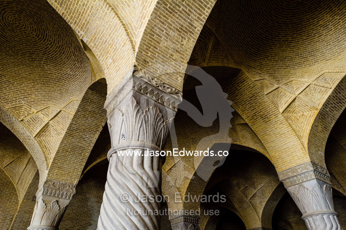 Vaulted ceilings supported by stone columns covered in coiling rope patterns in the Vakil Mosque. Vakil Mosque, Shiraz, Fars Province, Islamic Republic of Iran.