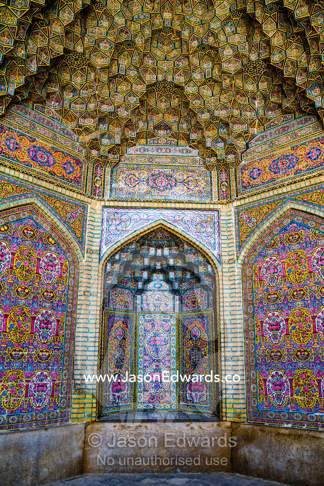 The intricate tiled muqarnas on the vaulted surface of the iwan of Nasir ol Molk Mosque. Nasir ol Molk Mosque, Shiraz, Fars Province, Islamic Republic of Iran.