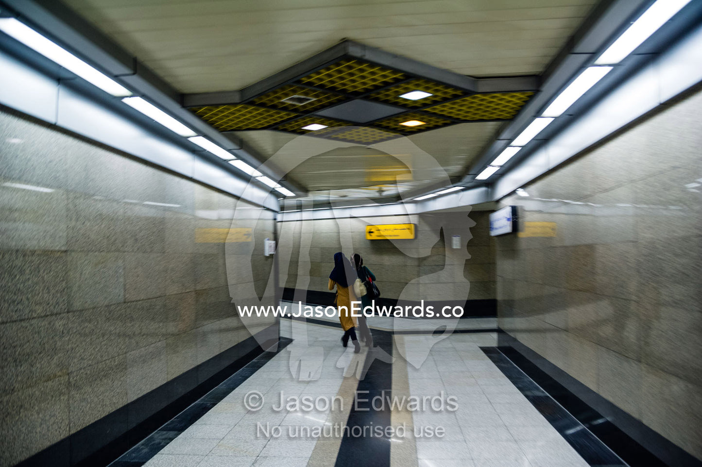 A commuter walks down a corridor in a railway subway system beneath Tehran. Tehran, Tehran Province, Islamic Republic of Iran.