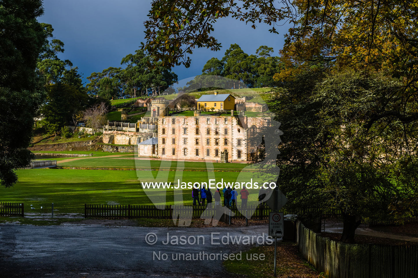 The facade and barred windows of the Port Arthur penitentiary overlooking a manicured lawn. Port Arthur Historic Site, Port Arthur, Tasmania,
Australia