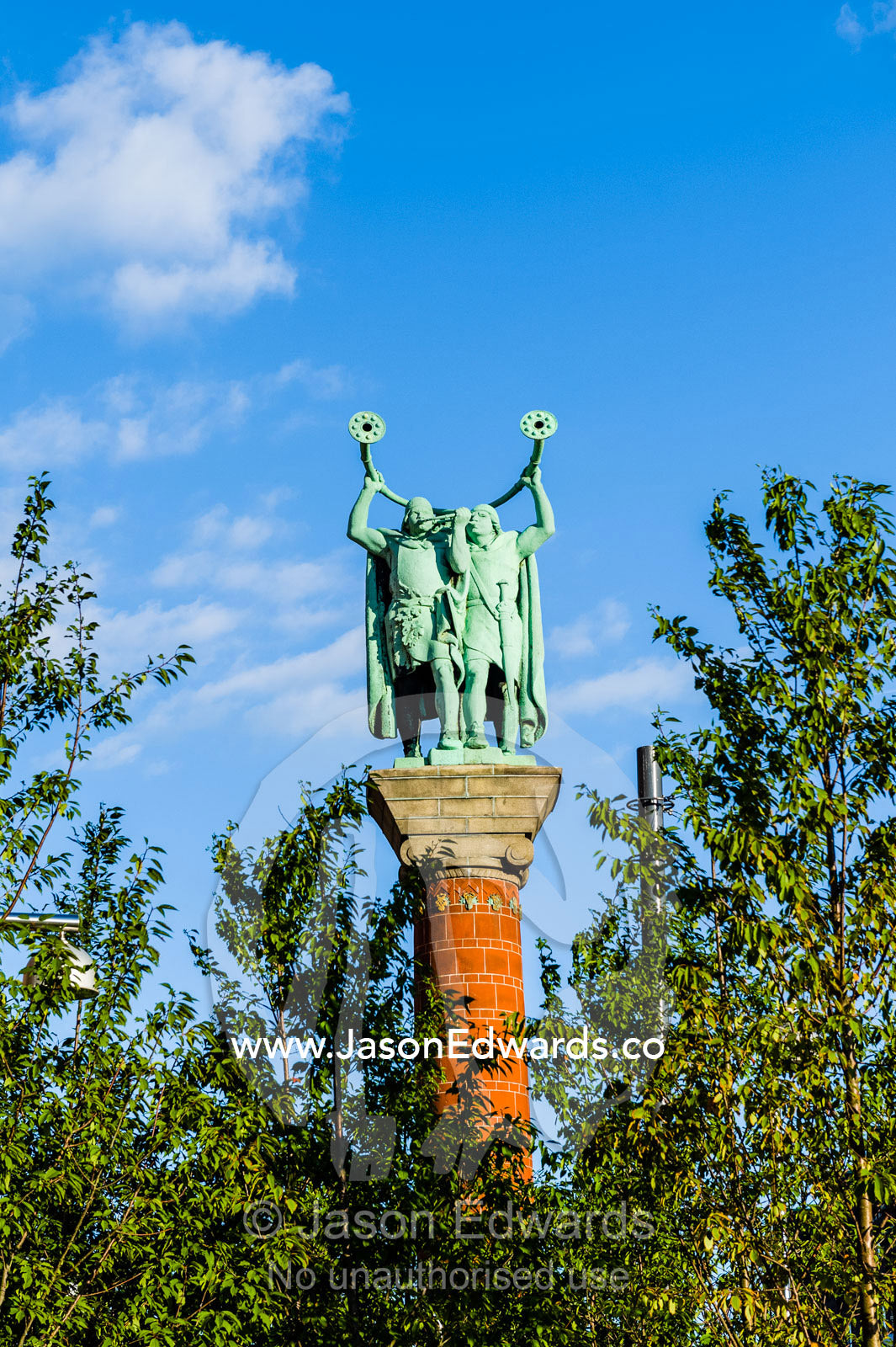 Two bronze Lur Blowers standing on their Column blowing an ancient type of trumpet called a Lure. Lur Blowers Statue, Town Square, Copenhagen, Denmark.