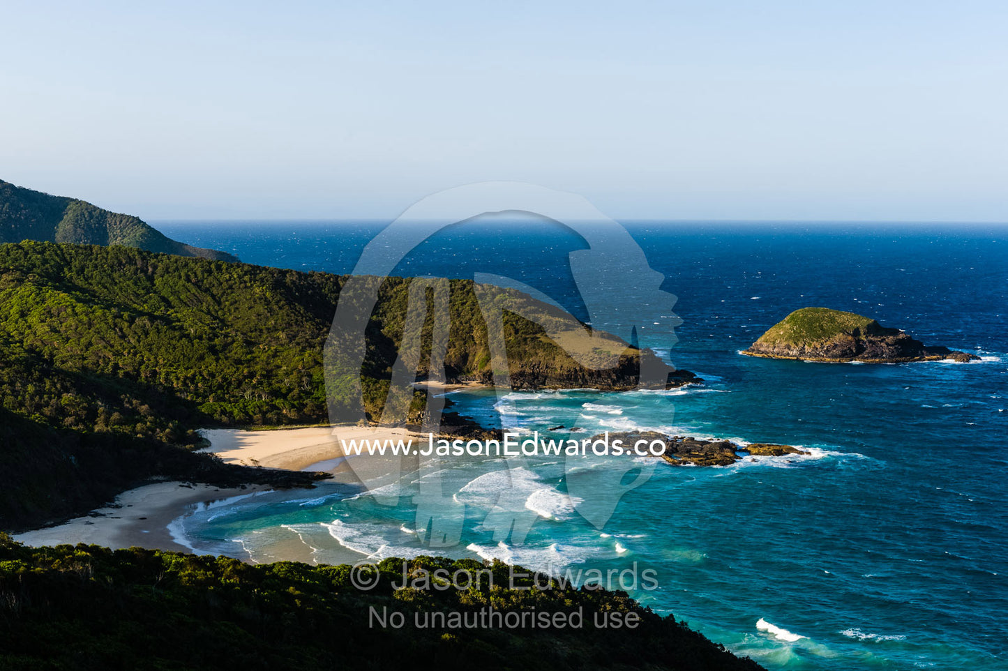 Uninhabited and pristine beaches beneath mountain forests on a rugged coastline. Smoky Cape Lighthouse, Hat Head National Park, New South Wales, Australia.