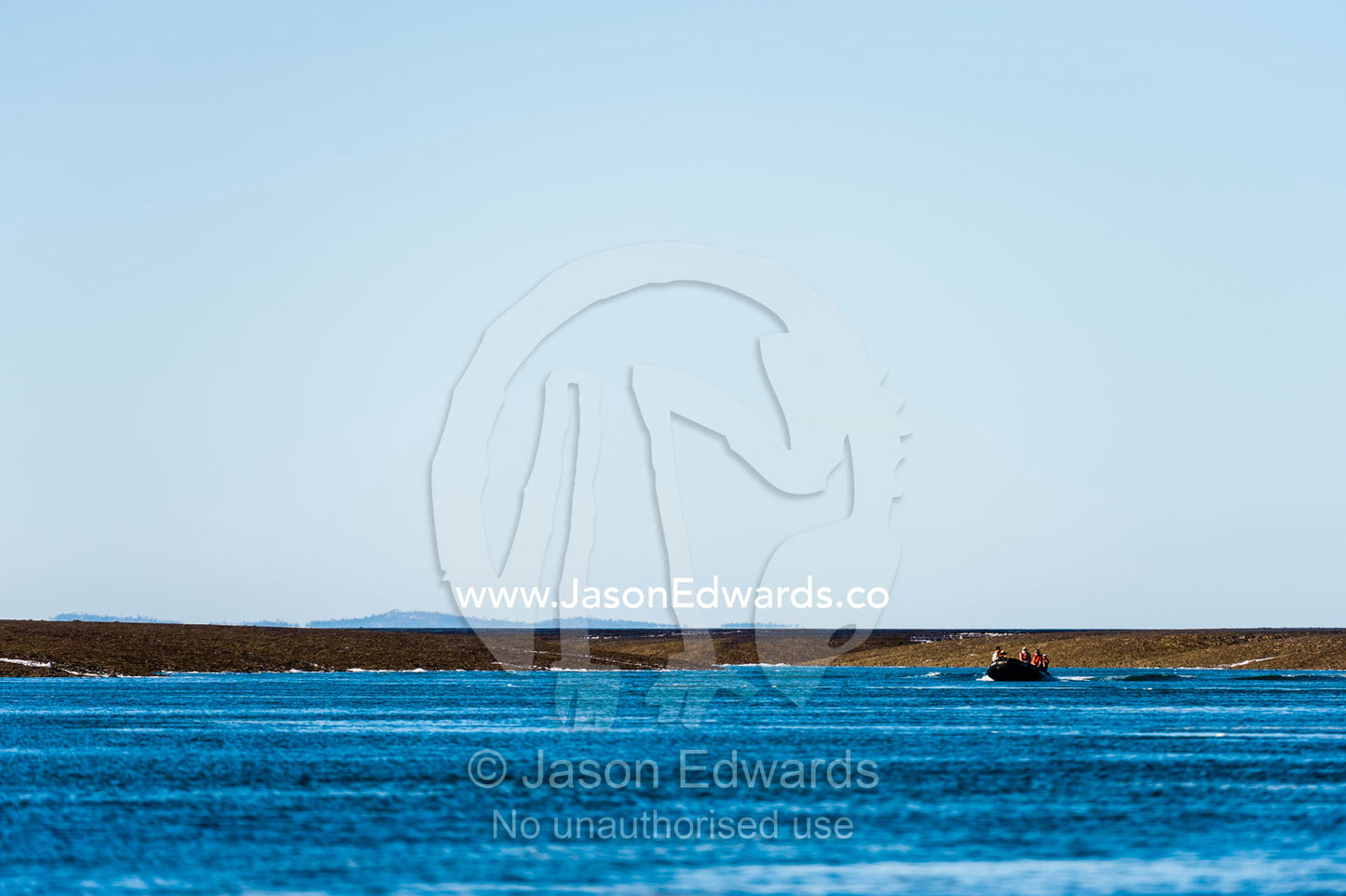 A zodiac carries tourists up a channel in an exposed reef at low tide. Montgomery Reef, Camden Sound, Kimberley Coast, Western Australia, Australia.