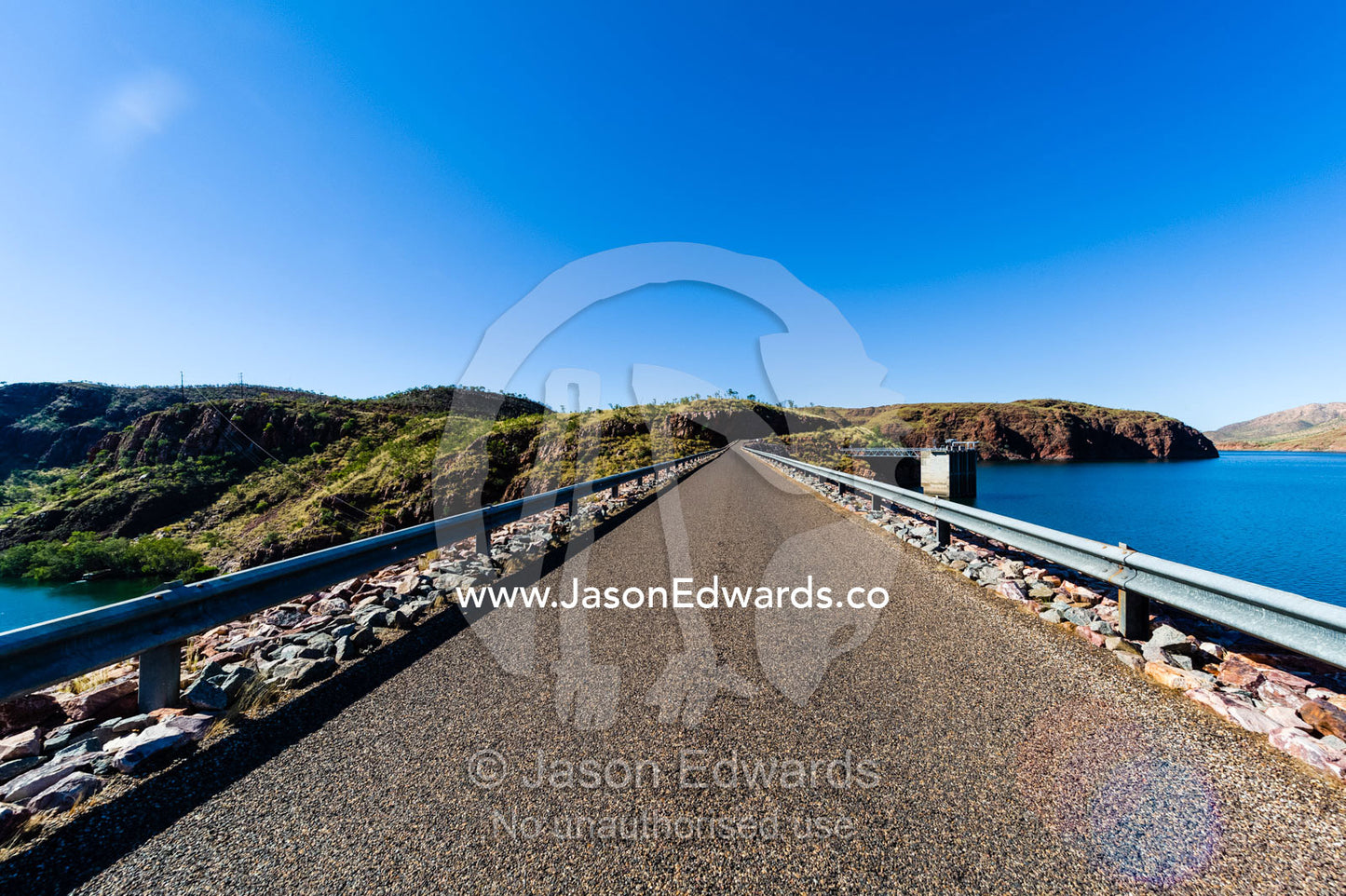A road across the top if the Lake Argyle Ord River dam wall. Ord River Dam, Lake Argyle, Kimberley Coast, Western Australia, Australia.