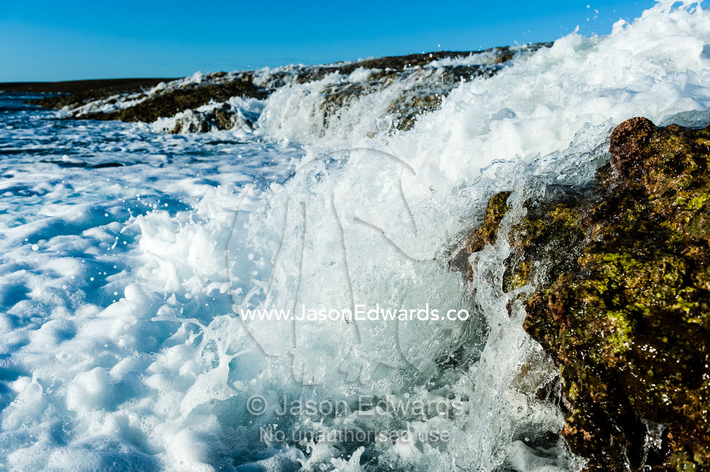 Water cascades from the surface of an exposed coral reef at low tide. Montgomery Reef, Camden Sound, Kimberley Coast, Western Australia, Australia.