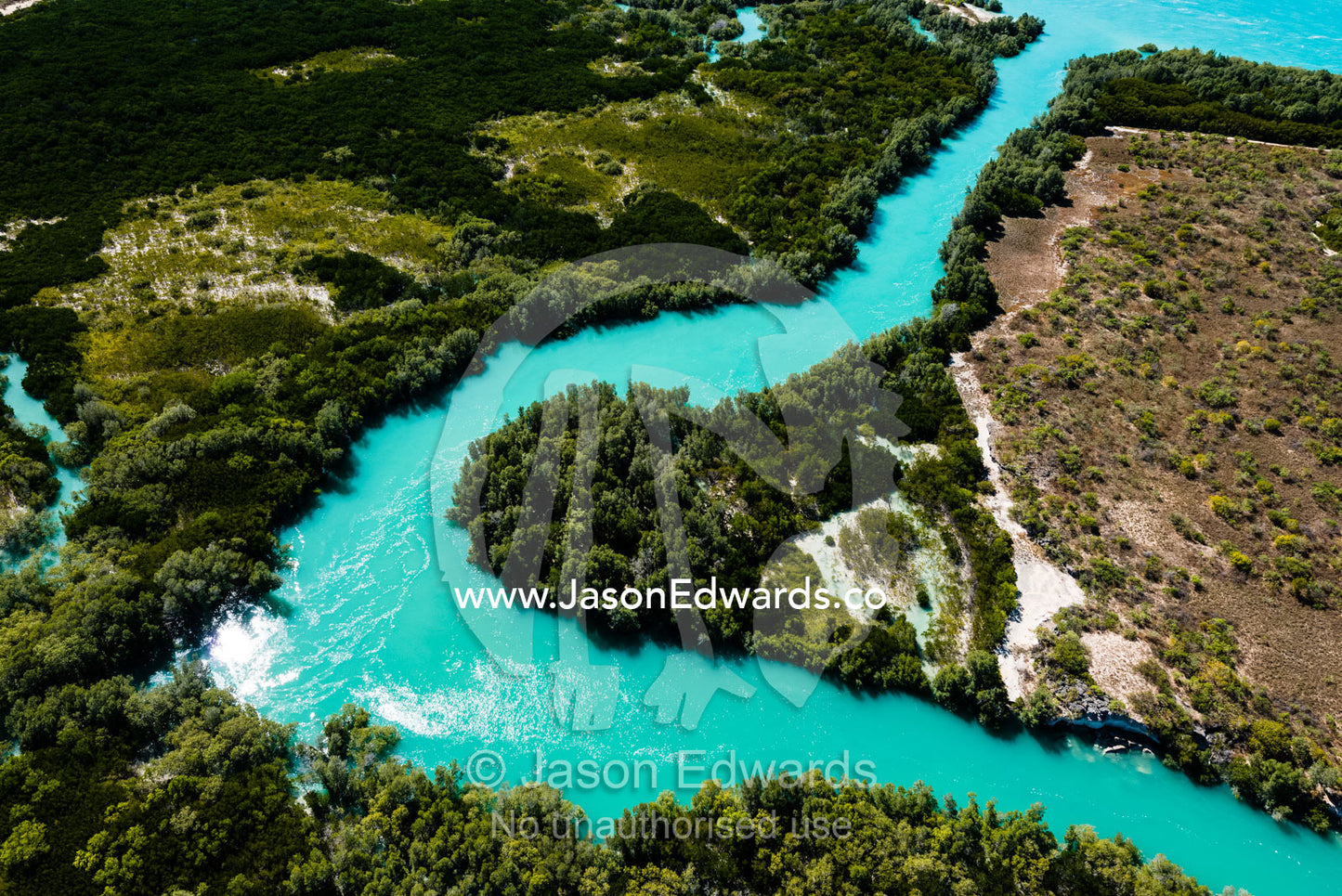 A turquoise tidal river winding it's way through mangroves in a tidal estuary. Willie Creek, Willie Creek Pearl Farm, Broome, Western Australia, Australia.