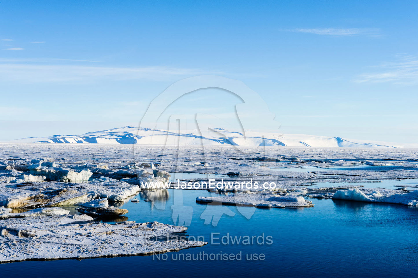 Ocean melt ponds expand where the Antarctic sea ice is melting in summer. Haskell Strait, McMurdo Sound, Ross Island, Antarctica.