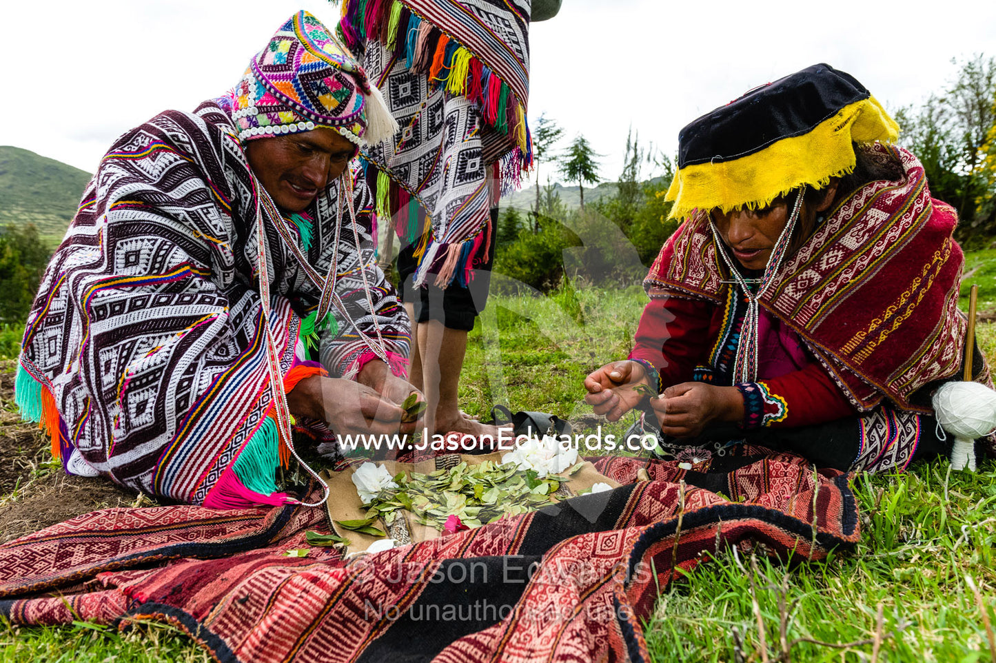 Amaru people from the Andes performing a Pachamama ceremony involving leaves and flowers. Peru.