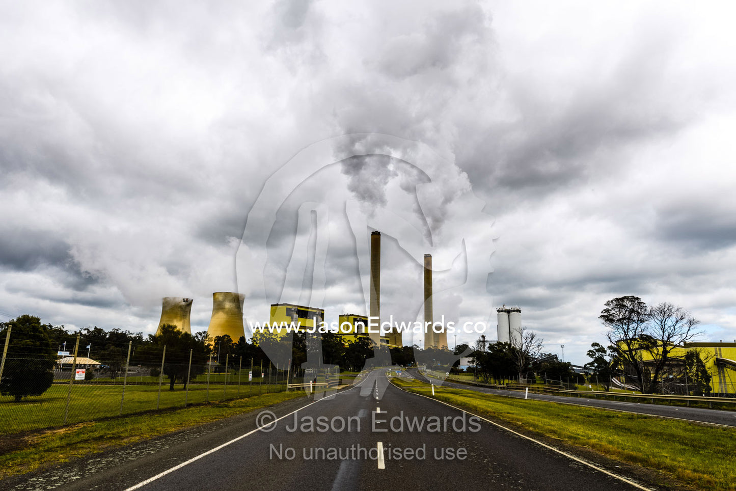 Steam and pollution pour from chimneys at a coal powered electricity station. Traralgon, Victoria, Australia.