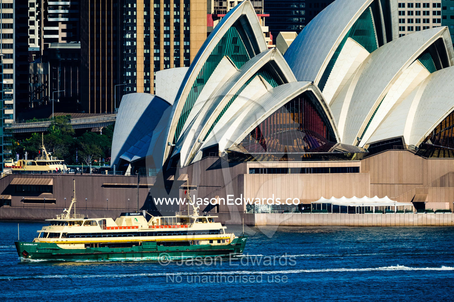 The Manly Ferry sailing past the Sydney Opera House on Sydney Harbor. Sydney, New South Wales, Australia.