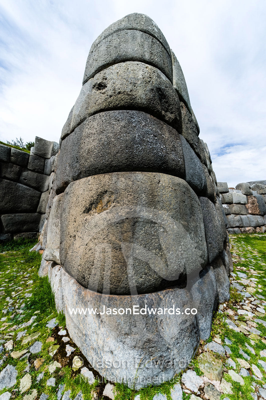 The Inca carved interlocking dry-stone walls from boulders to build a citadel terrace wall. Cusco, Peru.