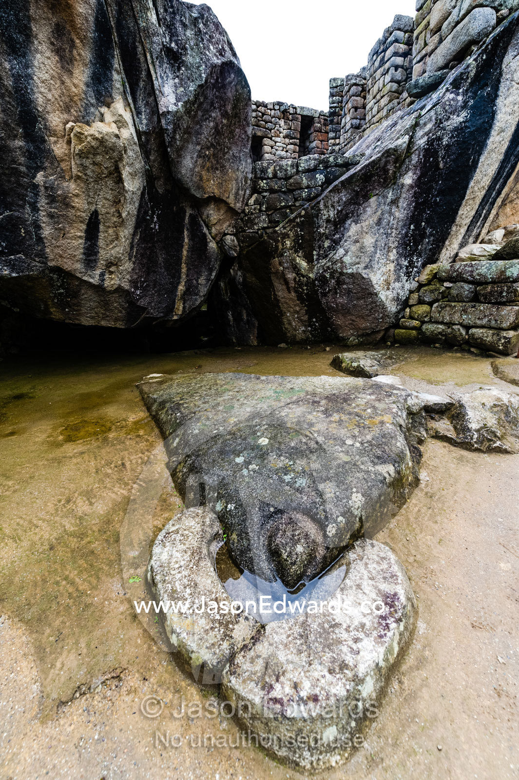 The Temple of the Condor with a carving of an Andean Condor head and an alter in a natural cave. Peru.