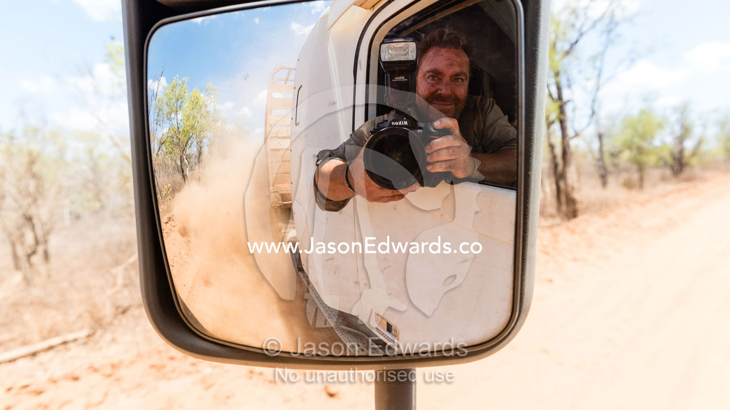 Self-portrait of photographer Jason Edwards riding in a truck on a remote cattle station. Bullo River Station, Northern Territory, Australia