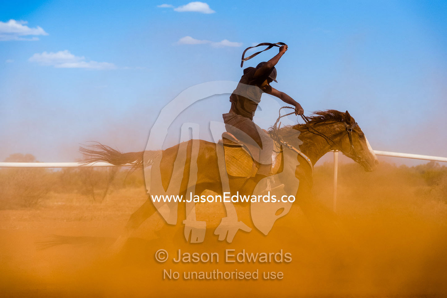 Aboriginal cowboys known as musterers compete at a horse racing carnival on a dusty outback track. Wallace Rockhole, Kwala Races, Hermannsberg Race T, Northern Territory, Australia