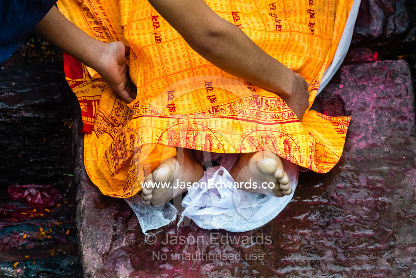 At a Hindu temple by a holy river family and friends offer prayers and offerings to a family member during a cremation. Kathmandu, Pashupatinath Temple, Nepal