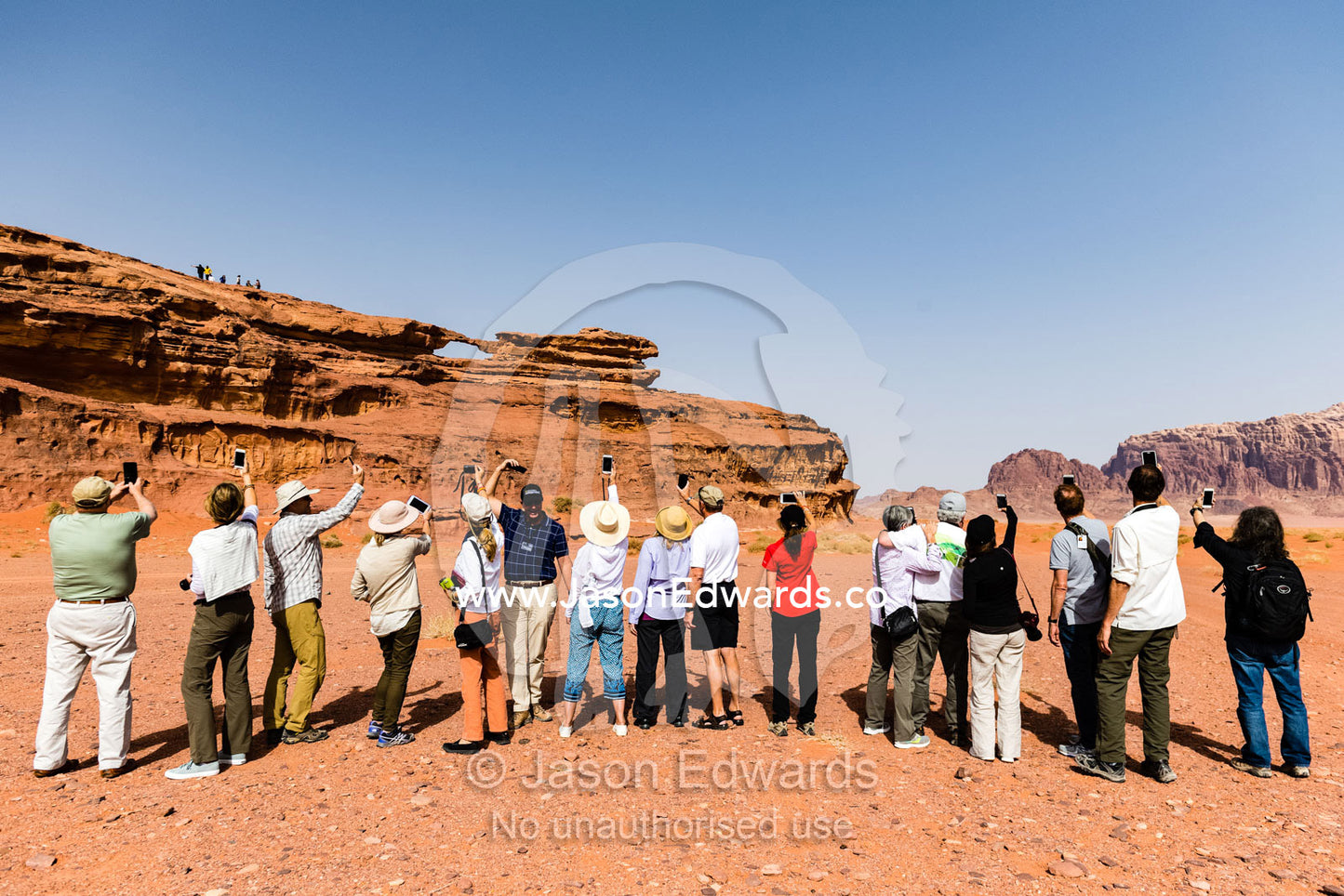 A group of tourists photographing the desert landscape with their smart phones. Wadi Rum, The Valley of the Moon, Jordan