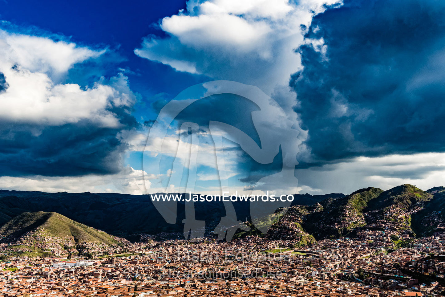Ominous storm clouds gather over the Andes and terracotta rooftops of Cusco. Cusco, Cusco Region, Peru