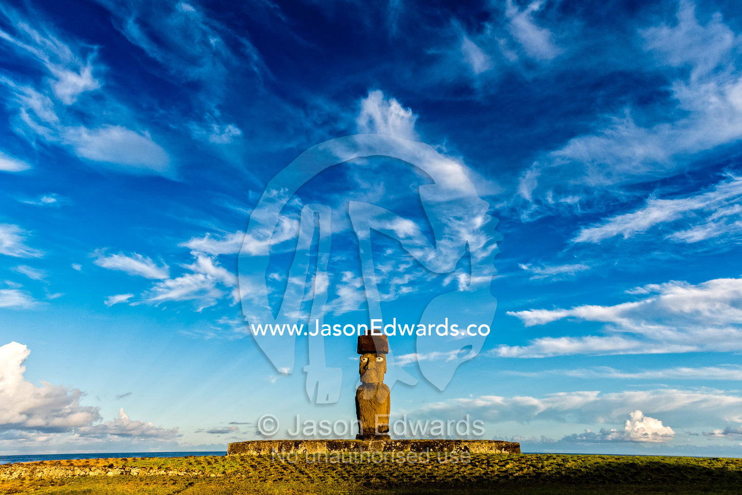 The human figure of a Moai statue wearing a topknot on the coast of Easter Island. Ahu Tahai, Rapa Nui, Easter Island, Chile