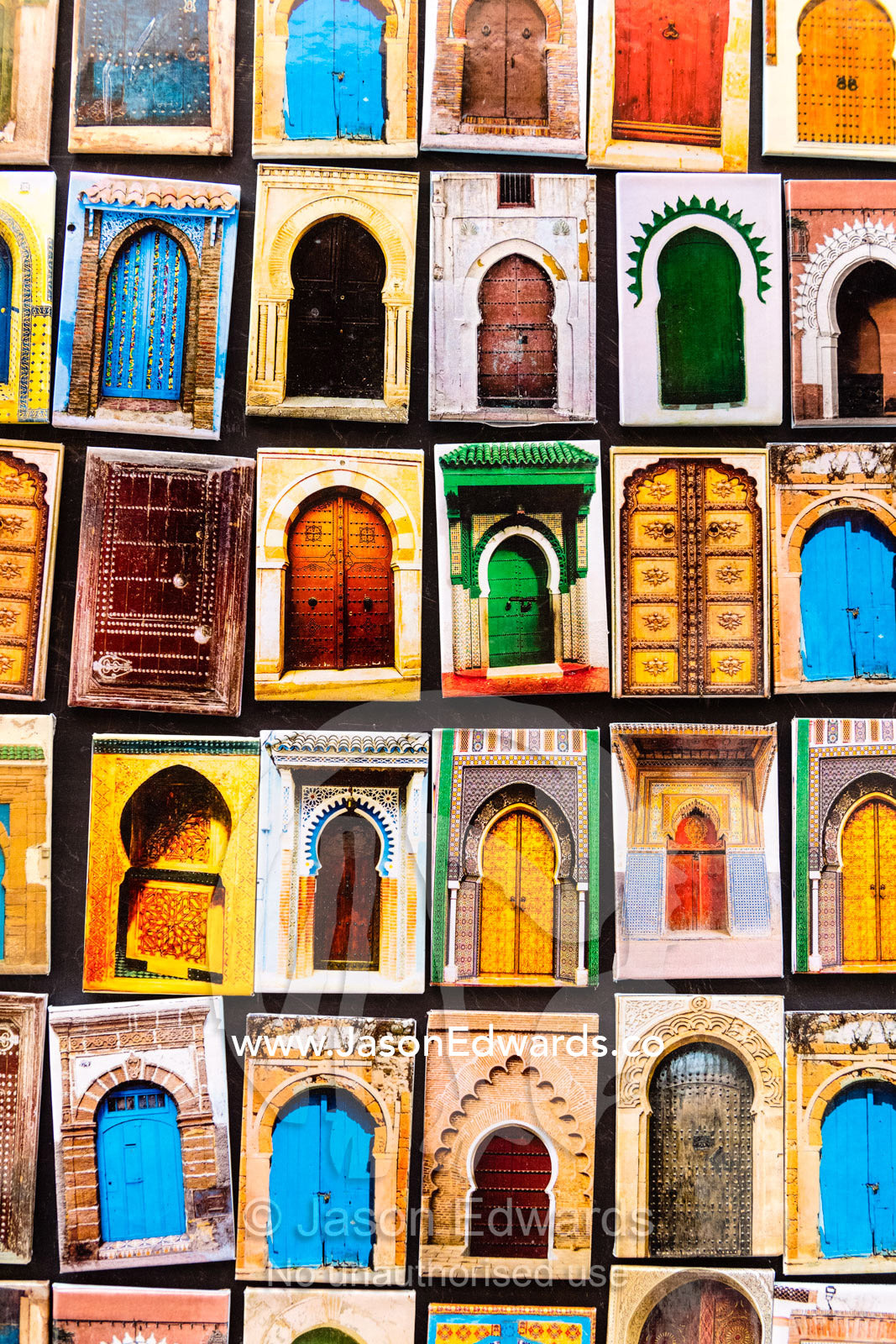 A collection of refrigerator magnets featuring colorful doors in Morocco. Marrakech, Marrakech Souk, Medina of Marrak, Morocco