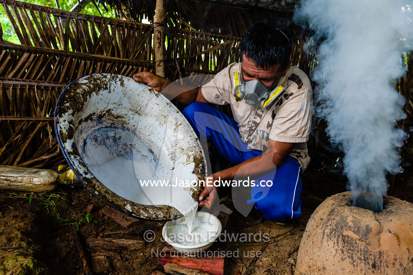 A rubber tapper pours rubber harvested from the Amazon rainforest to paint on vinyl sheets to make handbags. Ecomusa Rubber Tapper Concession, Madre de Dios Region, Peru