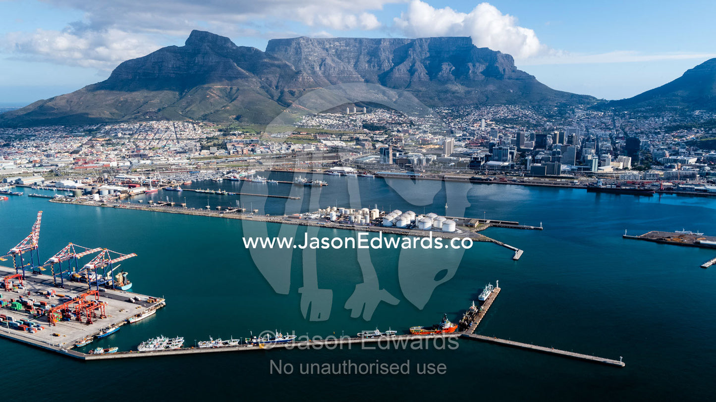 A shipping cargo port and oil refinery in the harbor near Cape Town and Table Mountain. Cape Town, Western Cape, South Africa