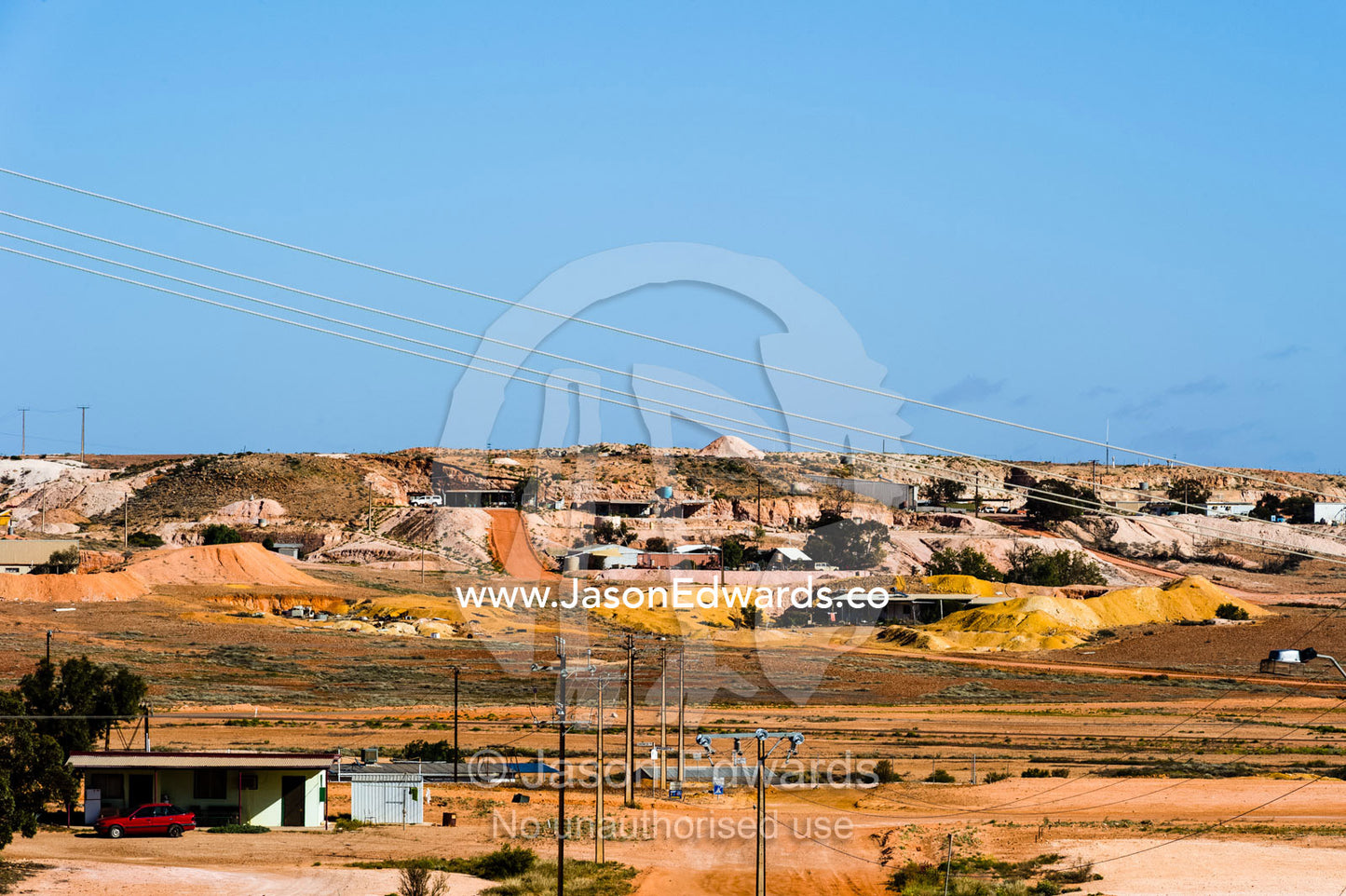 Slurry mounds surround the entrances to underground homes known as dugouts in the desert. Coober Pedy, South Australia, Australia