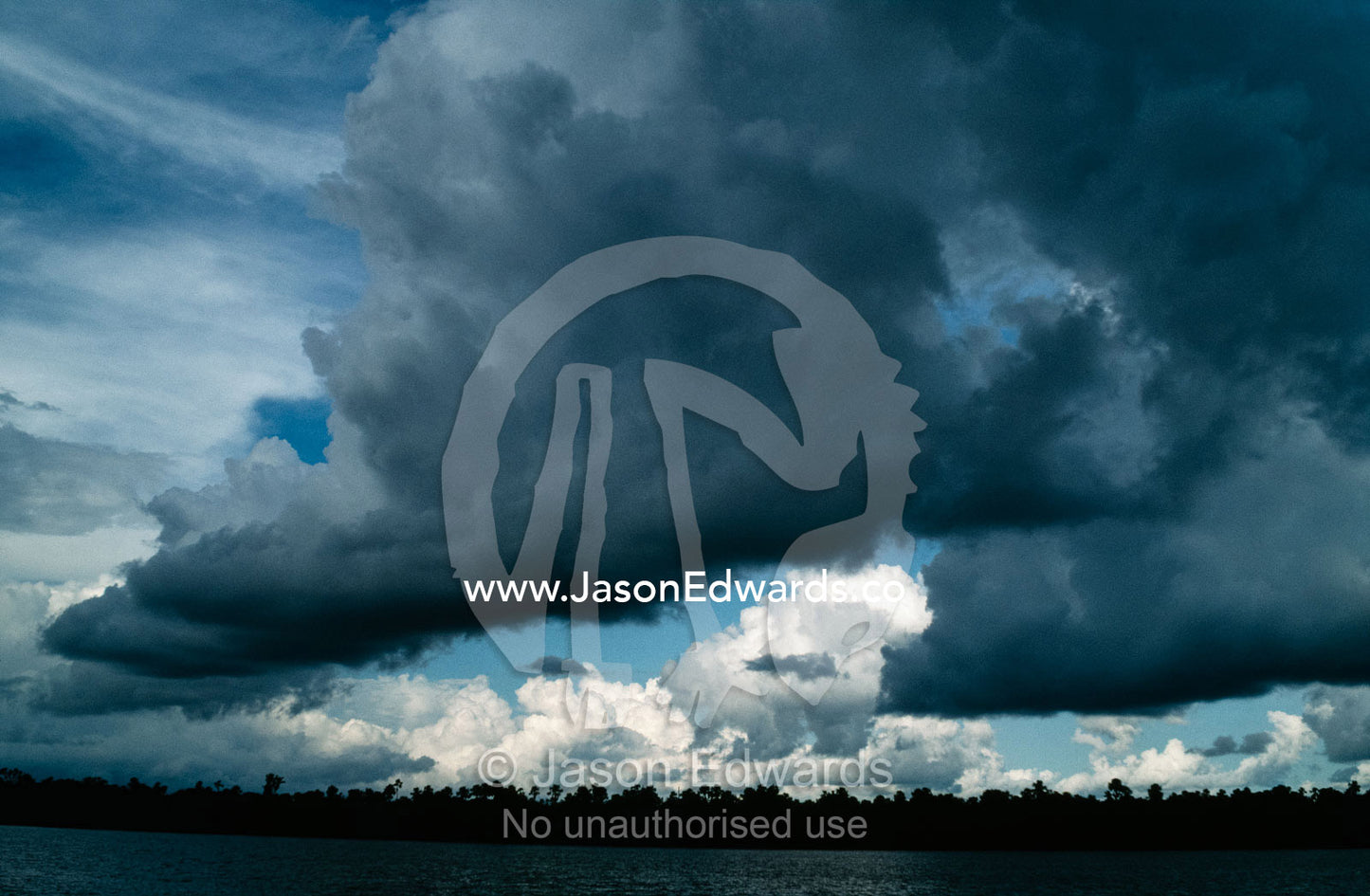 An immense tropical storm forms over the Amazon River. Amazon River Basin, Peru.