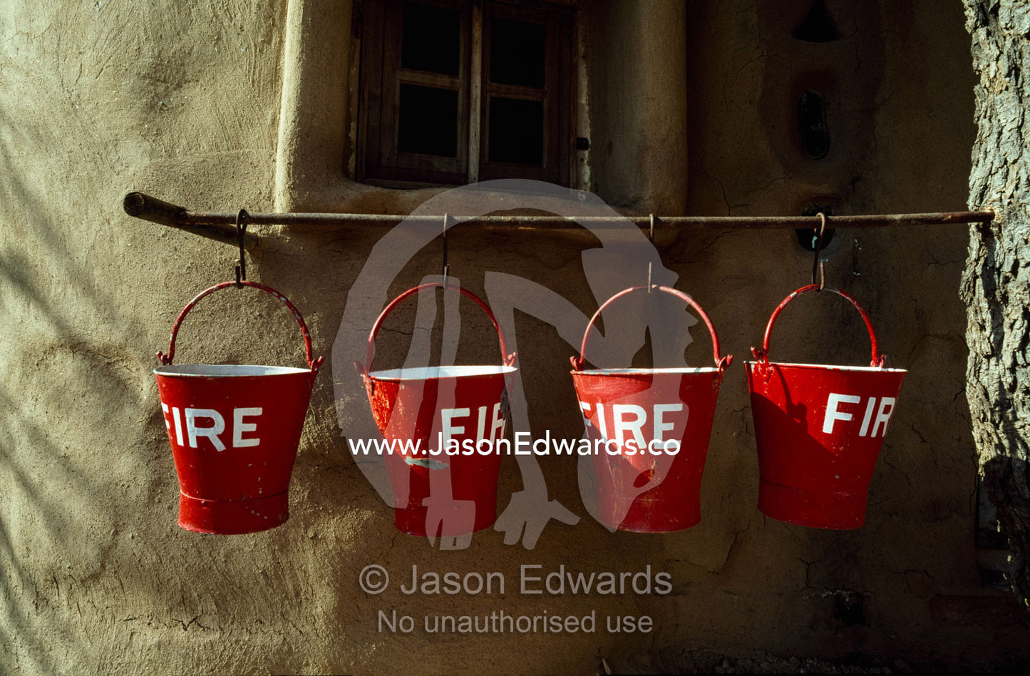Fire buckets filled with sand outside a clay and straw desert hut. Mandawa, Rajasthan State, India.
