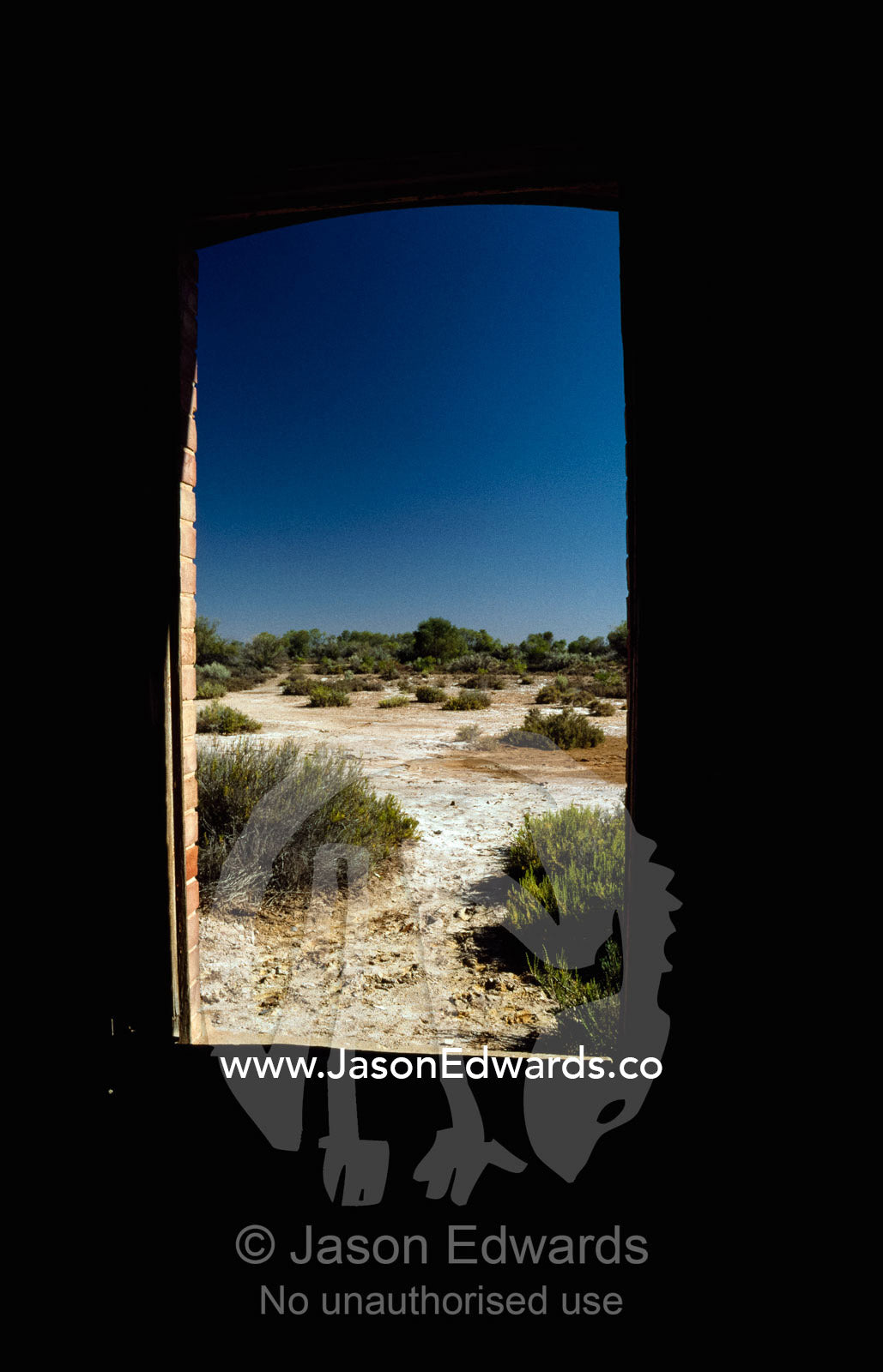 Landscape seen through the window of an abandoned railway station. Curdimurka, South Australia, Australia.