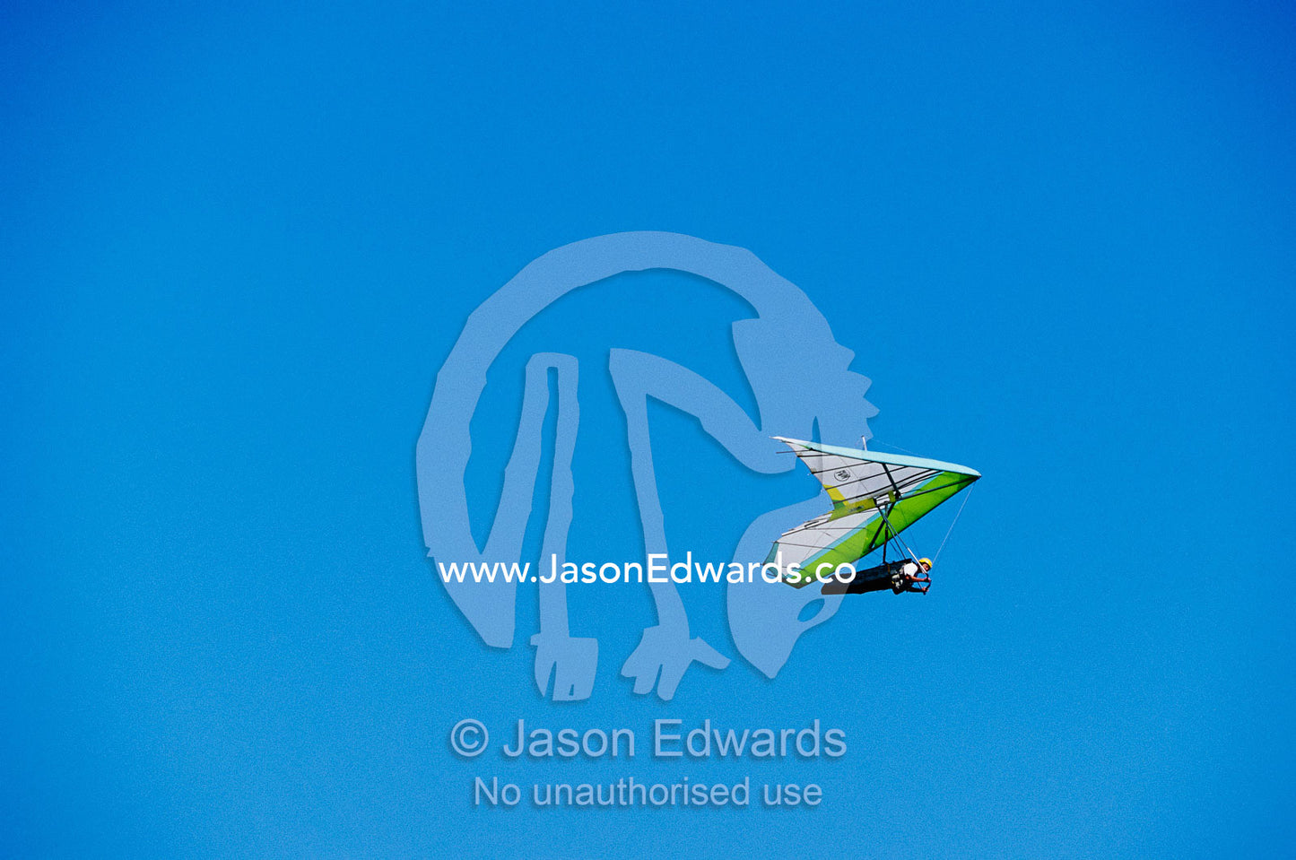 A hang glider in clear blue sky. Merewether, New South Wales, Australia.