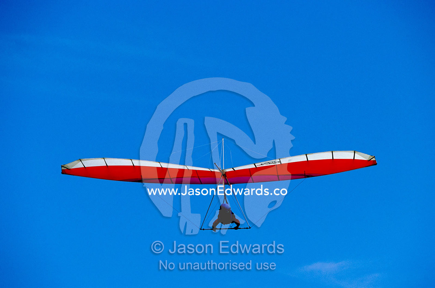 A hang glider in clear blue sky. Merewether, New South Wales, Australia.