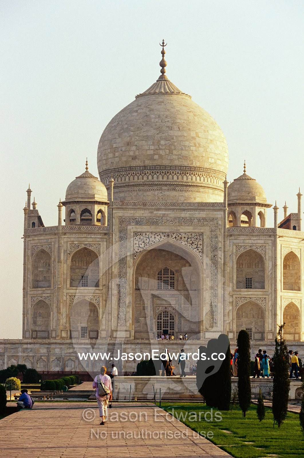 Tourists walking through gardens on grounds of the Taj Mahal. Taj Mahal, Agra, India.