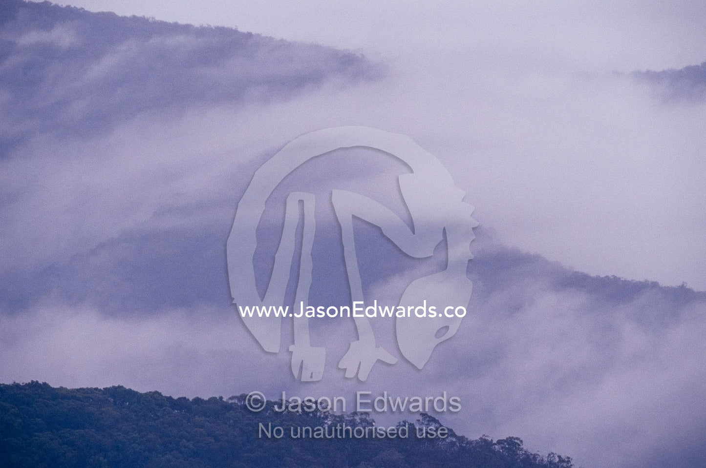 Storm clouds and mist rolling over rugged forested mountains. Eildon State Forest, Victoria, Australia.