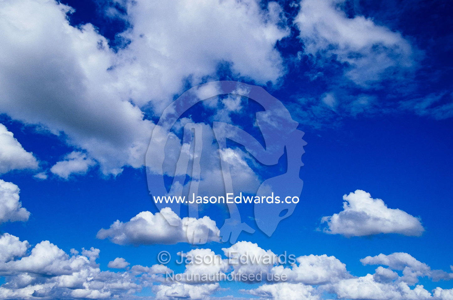 Sunlit fluffy white clouds in a blue sky. Near Carnarvon National Park, Queensland, Australia.